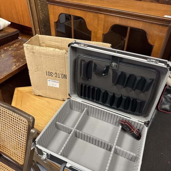 Open aluminium tool case with foam insert for tool storage.