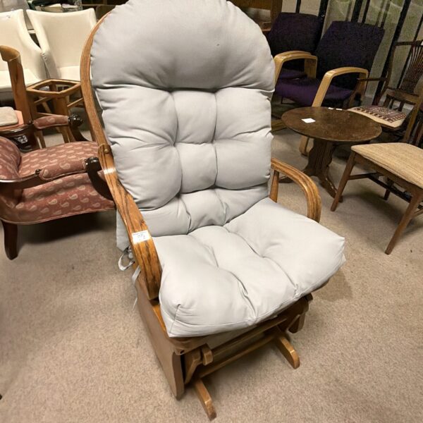 Vintage American oak rocking chair with comfortable upholstery.
