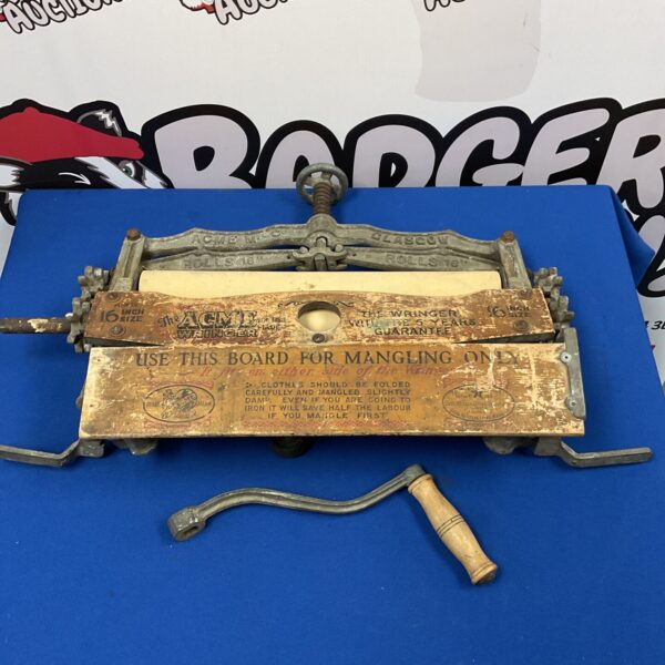 Antique Acme wringer mangle for squeezing laundry.