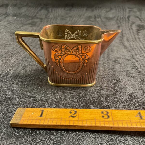 Antique Carl Deffner cream jug with embossed detailing.