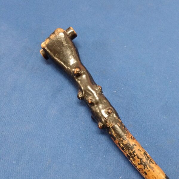 Close-up of antique carved fist walking stick handle.
