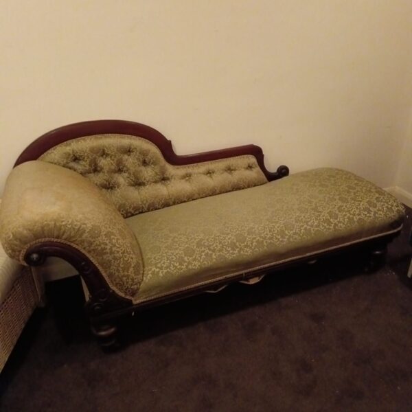 Antique Victorian chaise lounge from Drayton Hall, featuring patterned upholstery.