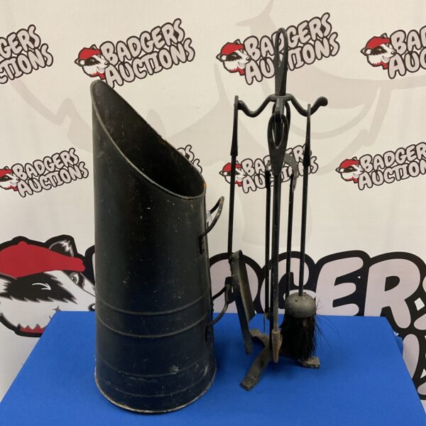 Antique coal scuttle and fireplace companion set for a vintage hearth.