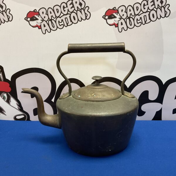 Antique copper kettle with curved handle and spout.