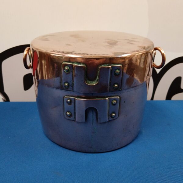 Antique copper mess tin with lid and handle, vintage camping equipment.