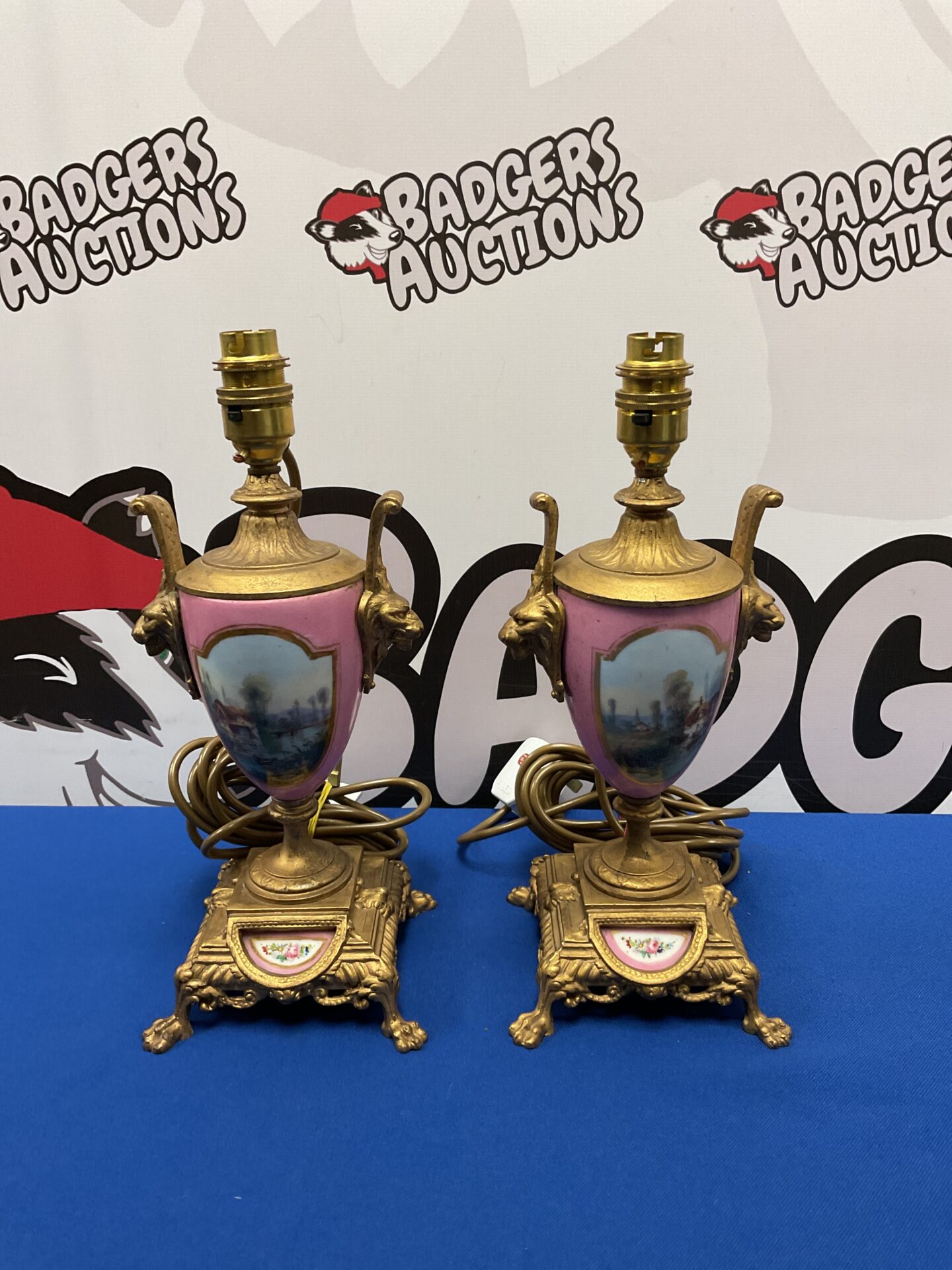 Antique garniture table lamps with porcelain and gilt detailing.