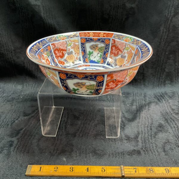 Antique Japanese Imari bowl with vibrant floral and bird designs.