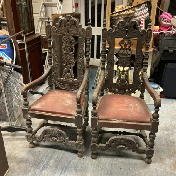 Pair of antique oak throne chairs with carved details.