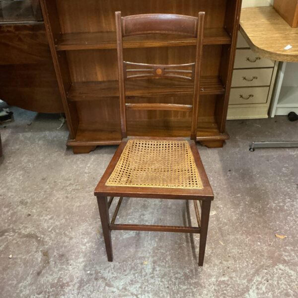 Antique rattan chair with woven seat and back, vintage style.
