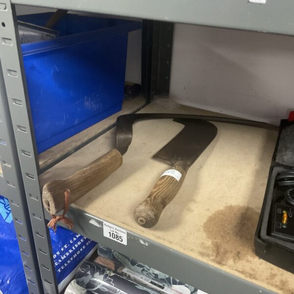 Antique scythe and bill hook set, vintage farm tools for collectors.