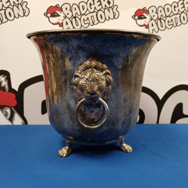 Antique silver plated ice bucket with striking lion mask handles.