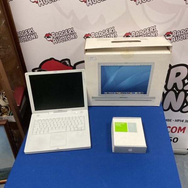 White Apple iBook G4 laptop in its original packaging.