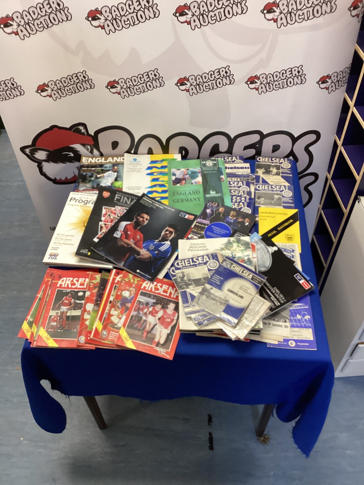 Vintage football programmes featuring Arsenal and Chelsea match details.