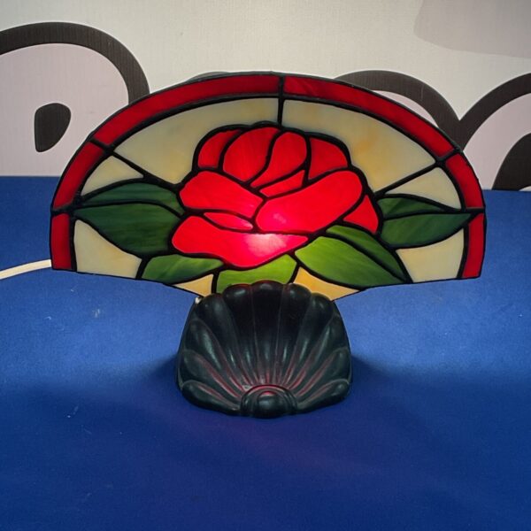 Vintage Art Deco table fan with floral stained glass shade.