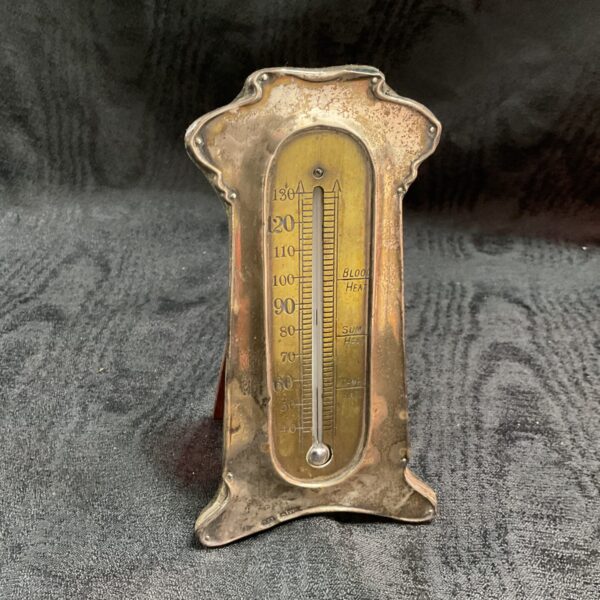 Antique Art Nouveau silver thermometer with floral detailing.