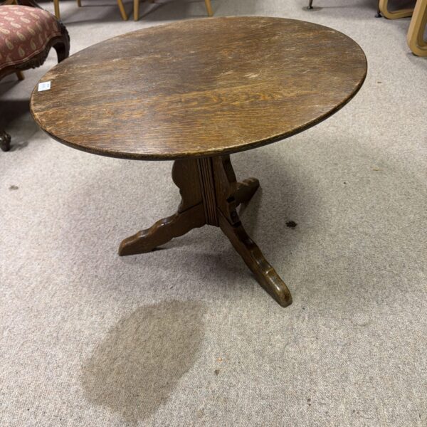 Antique Arts and Crafts oak occasional table with tripod legs.