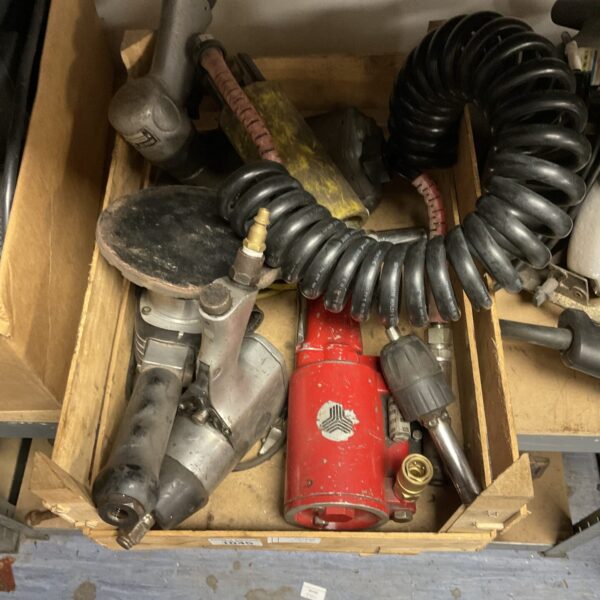 Assorted pneumatic air tools in a tray, including an air ratchet.