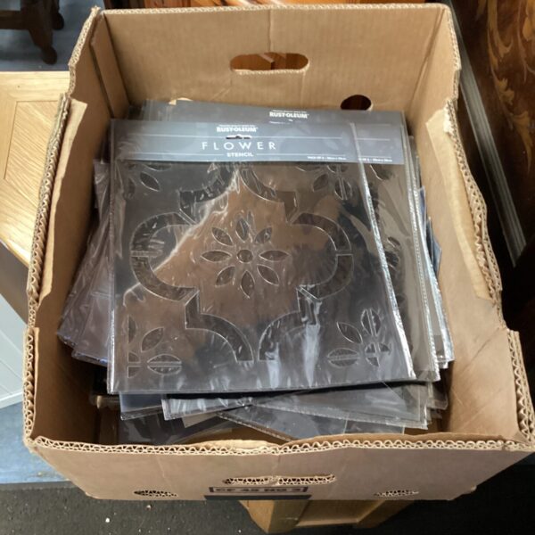 Box of assorted new stencils for crafting and painting projects.