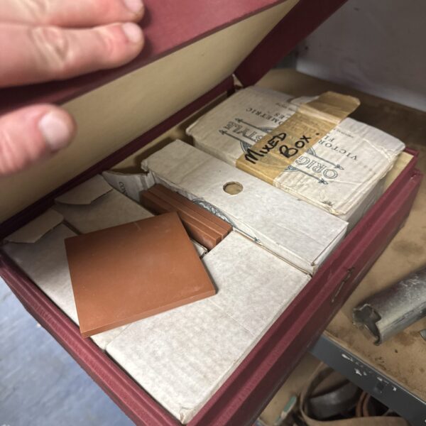 Assorted vintage ceramic tiles in a decorative lot.