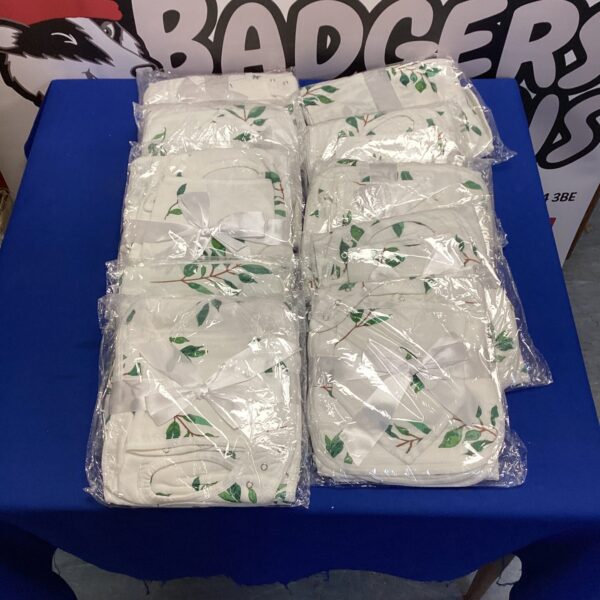 New baby bib set and changing base gift set, sealed in packaging.