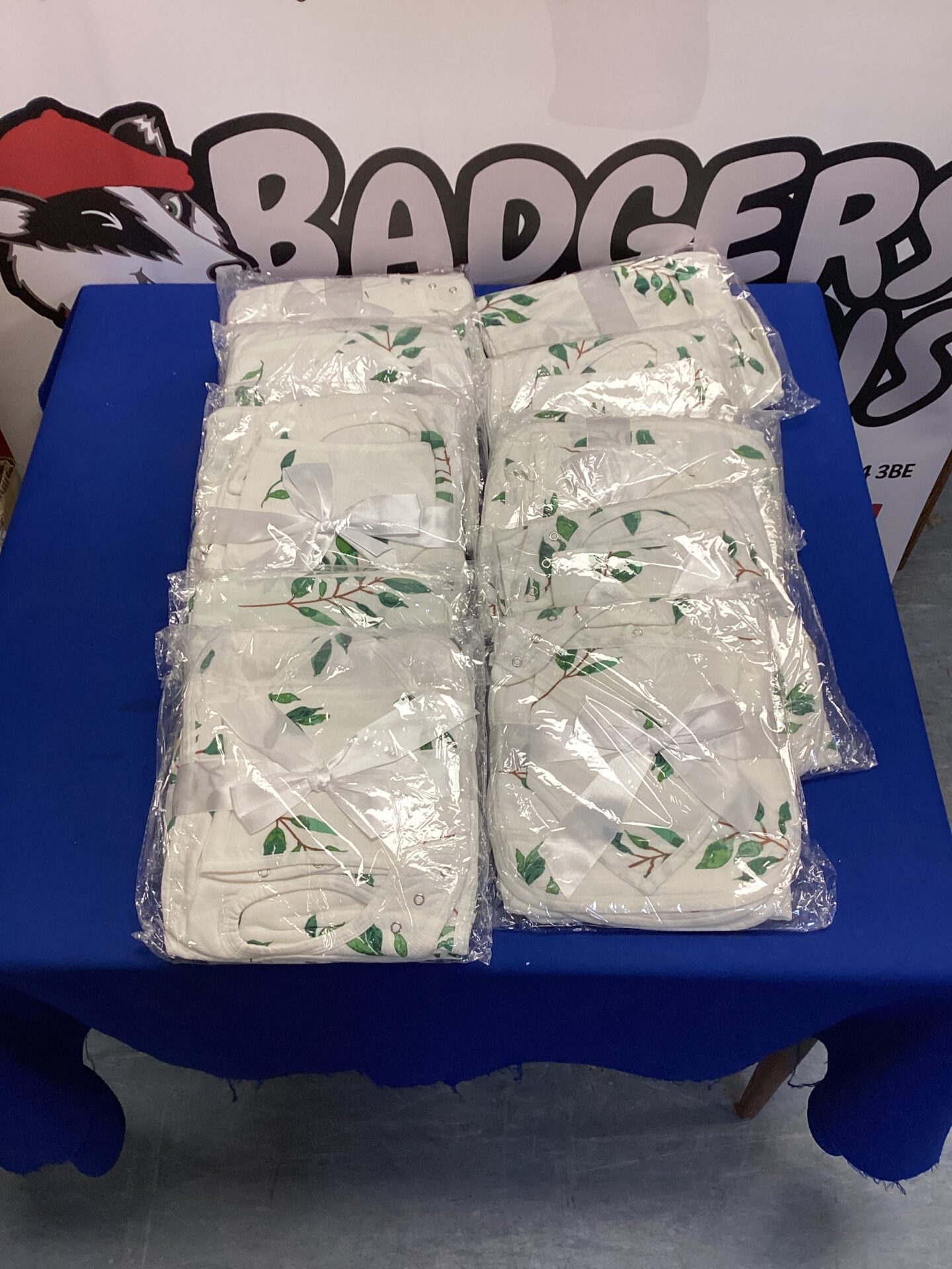 New baby bib set and changing base gift set, sealed in packaging.