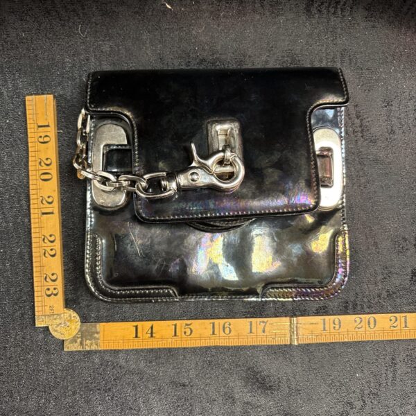 Front view of a Balenciaga oil slick clutch bag.