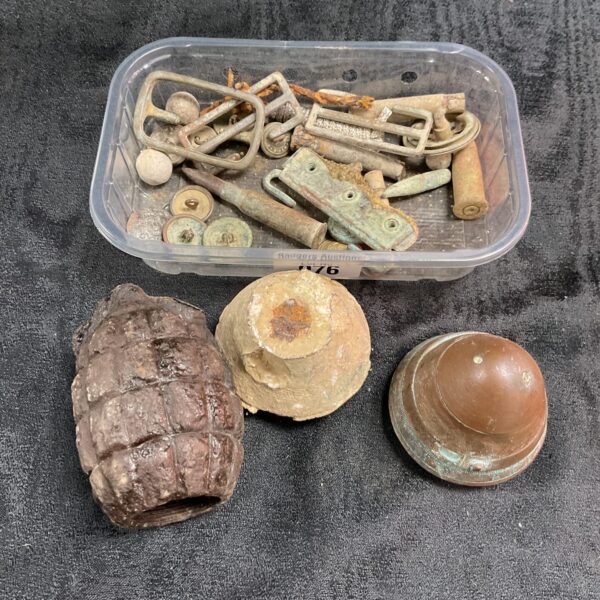 Collection of vintage grenade and shell fuses from a battlefield detector haul.