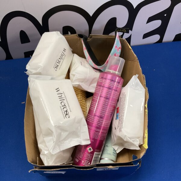 Beauty and haircare lot with hairspray, wipes, and brushes.