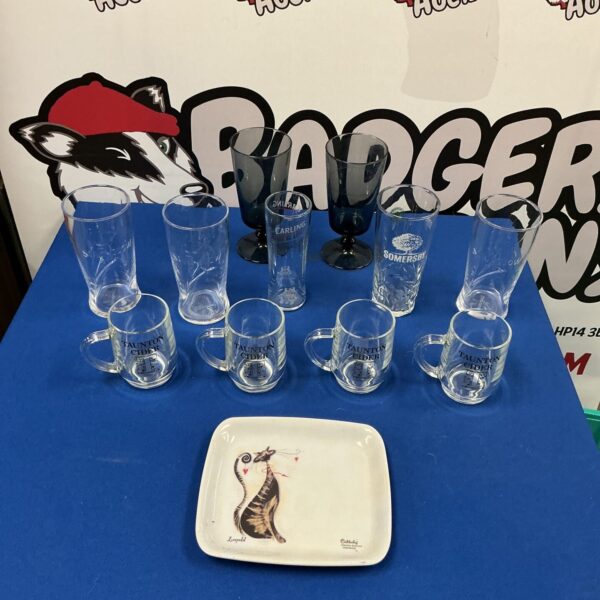 Assorted beer glass collection including Taunton Cider branded glass.