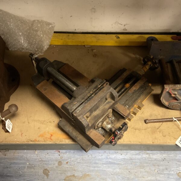 Vintage metal bench clamp for workshop use.