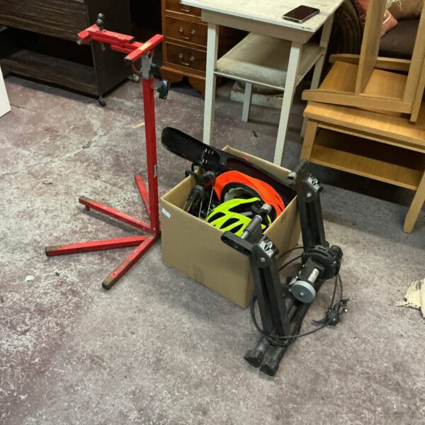 Bike trainer, bike stand, and spares lot for indoor cycling.
