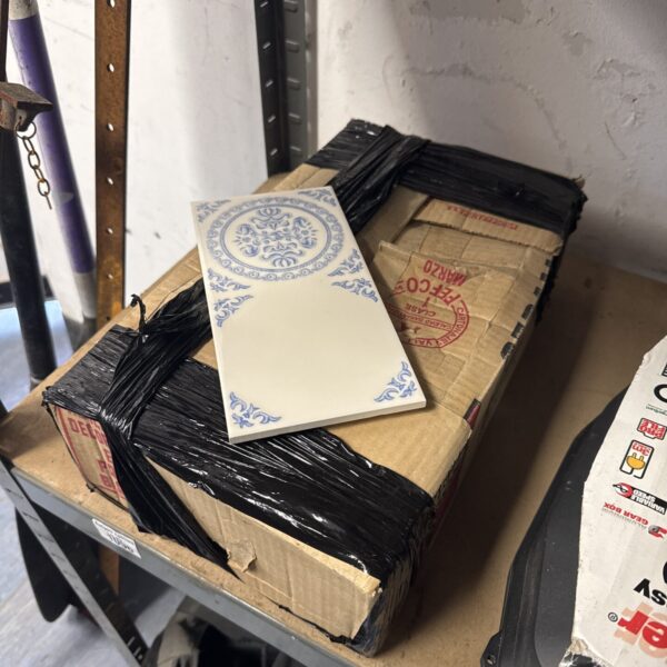 Box of vintage blue and white ceramic wall tiles.