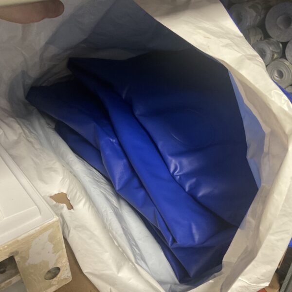 Blue inflatable air bed folded for storage.