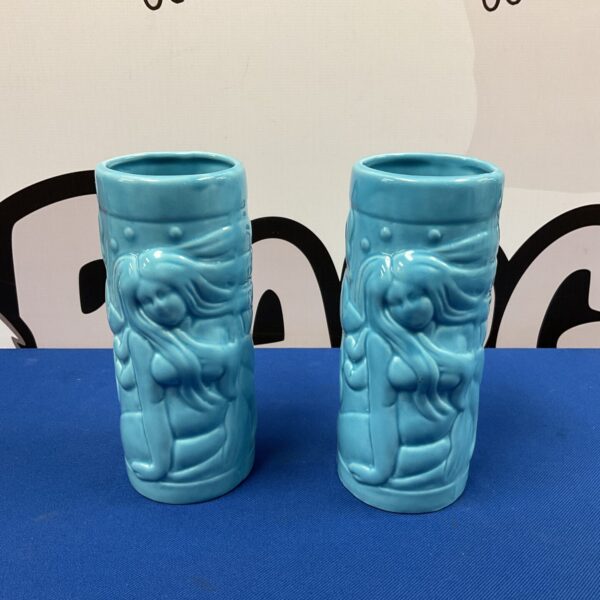 Pair of blue ceramic mermaid vases for home decor.