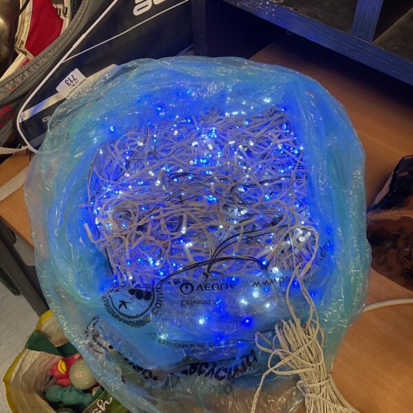 Long string of blue and white outdoor Christmas lights.