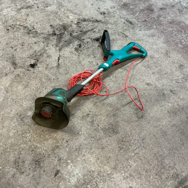 Electric Bosch garden strimmer for lawn edging and maintenance.