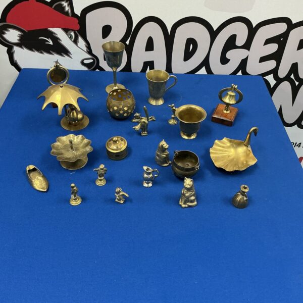 Vintage brass ornaments collection featuring cat figurines and decorative pieces.