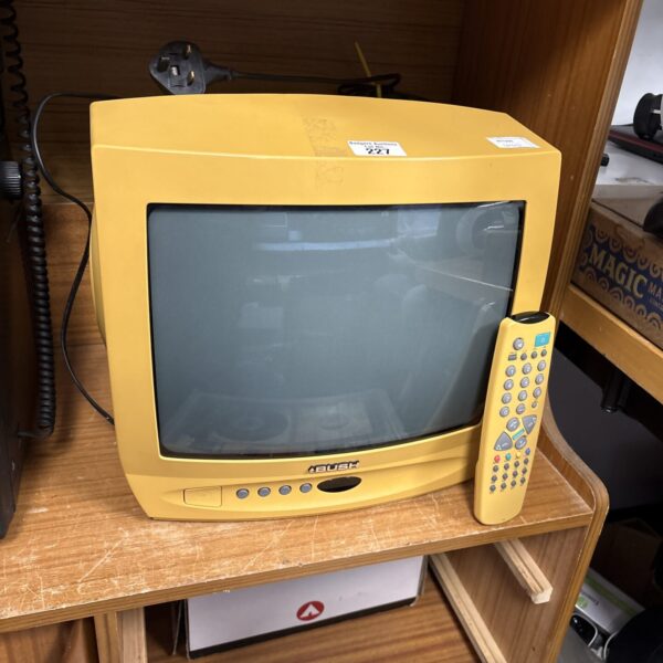 Yellow Bush CRT television with remote control.