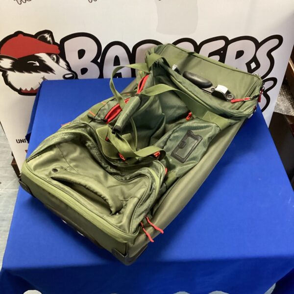 Dark green Caribee wheeled travel bag with pull handle.