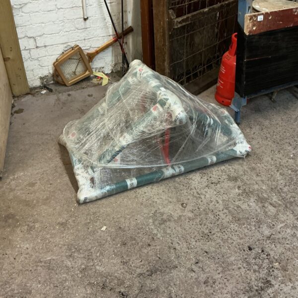 Wrapped carpet moving cart for flooring transport.