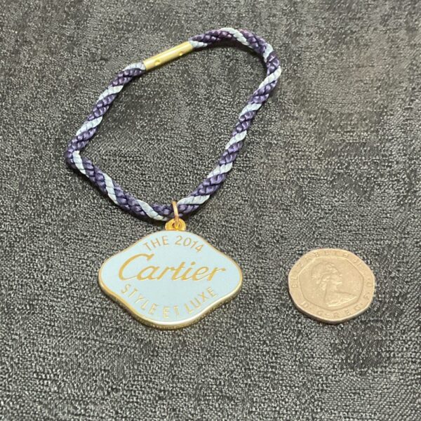Front view of the Cartier Style Et Luxe fob with woven cord.