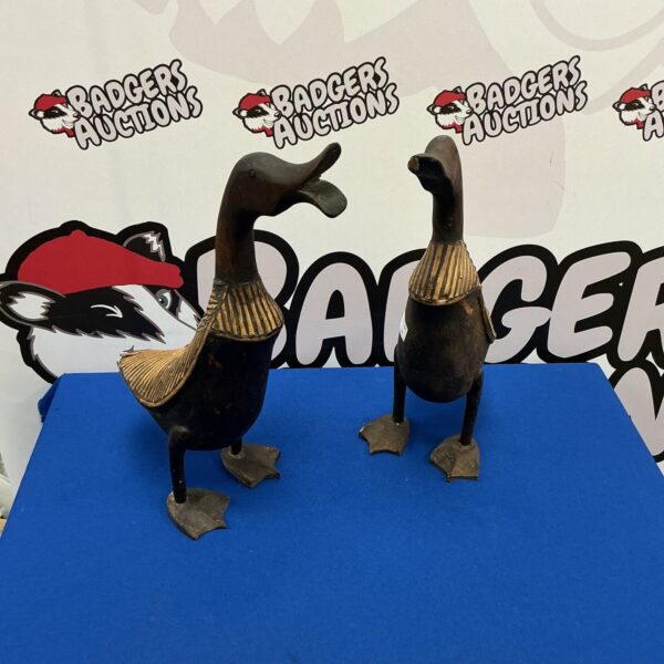 Pair of vintage carved wooden ducks for home decor.