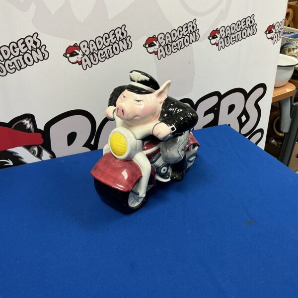 Vintage ceramic cookie jar featuring a biker on a motorcycle.