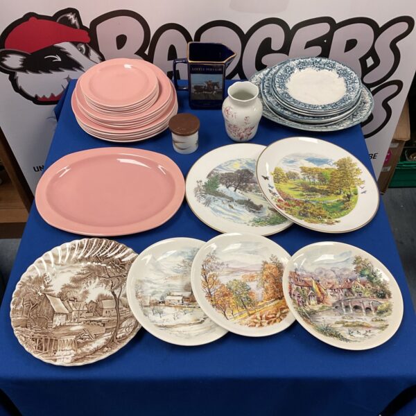 Vintage china plates and a Little Polveir pub jug in a collection.