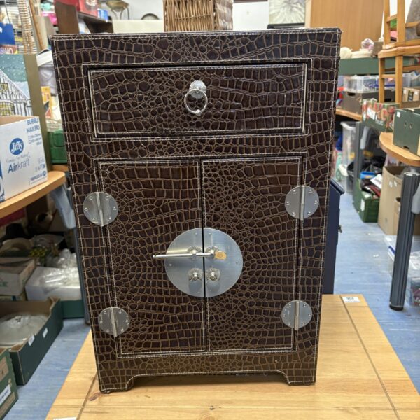 Front view of a luxurious Chinese crocodile cabinet with drawers.