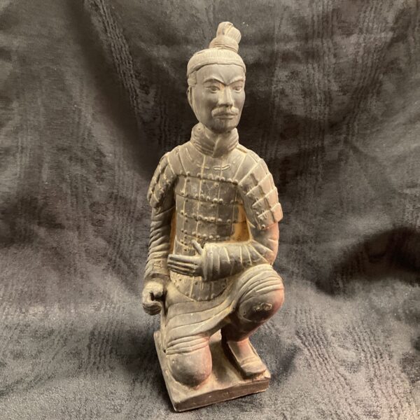 Antique Chinese terracotta warrior statue, detailed armour, kneeling pose.