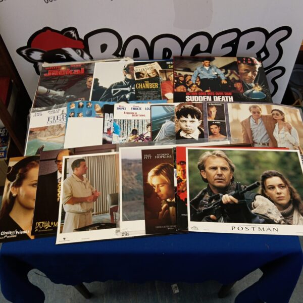 Vintage cinema lobby posters featuring Bruce Willis and Claude Van Damme.