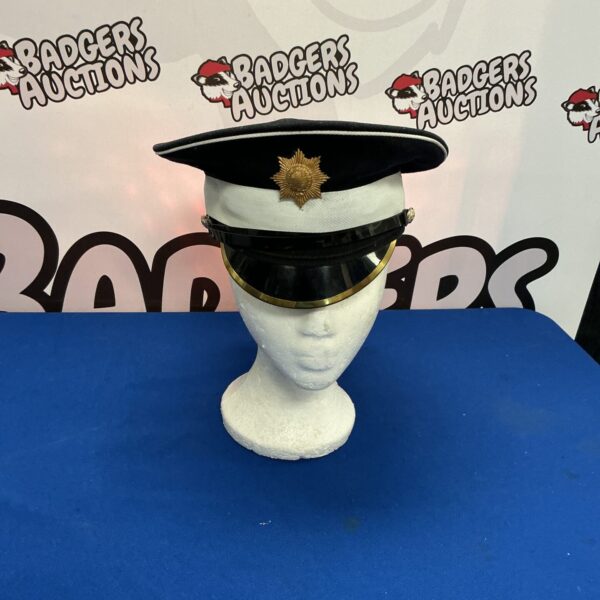 Front view of a scarlet Coldstream Guards dress hat with black plume.