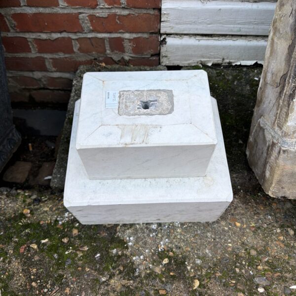 Weathered concrete water feature for a garden pond.