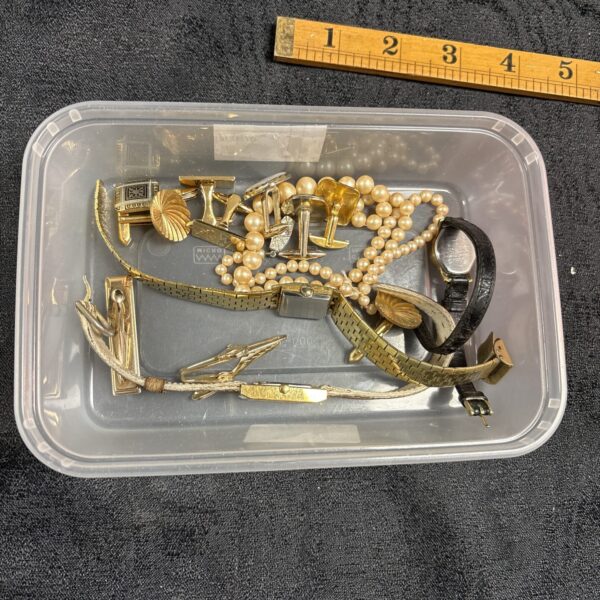 Mixed lot of vintage costume jewellery and watches on display.